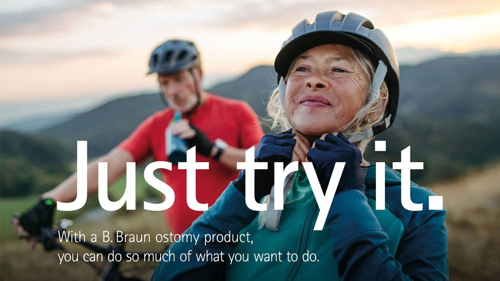 Two cyclists taking a break in the mountains, one drinking water and the other adjusting a helmet, with scenic mountain views in the background. The text on the image reads Just try it. With a B. Braun ostomy product, you can do so much of what you want to.