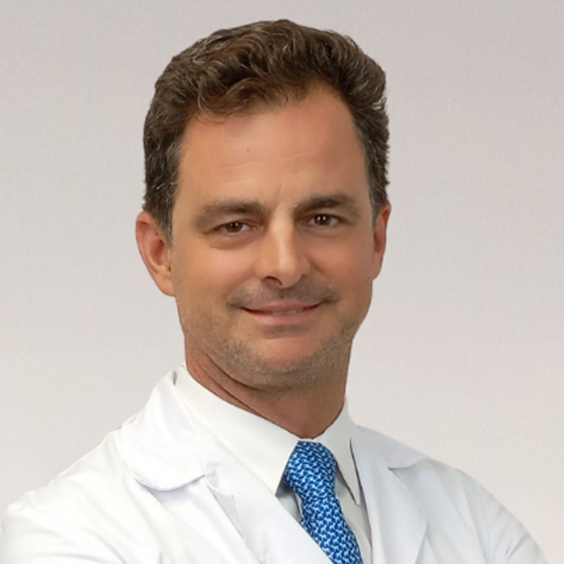 Retrato del profesor Javier López Monclús con el abrigo de un médico sonriendo con confianza a la cámara